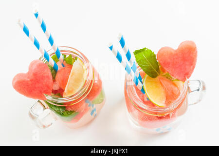 Top view of sweet watermelon lemonade in Mason jars with mint, lime, straws Stock Photo