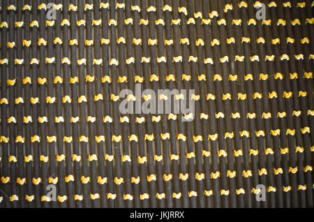 Black gray fishnet cloth material texture background. Black texture and yellow background with copy space for text or image. Stock Photo