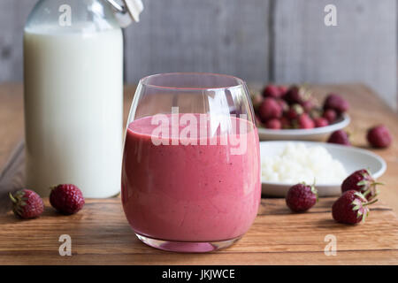 Milk kefir with strawberries on a wooden background Stock Photo