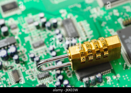 Lock on the background of the computer motherboard, the concept of cyber security Stock Photo