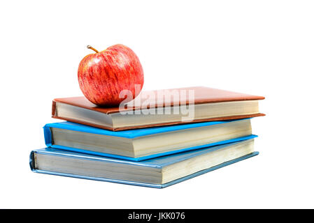 Heap of books with apple isolated on white background Stock Photo