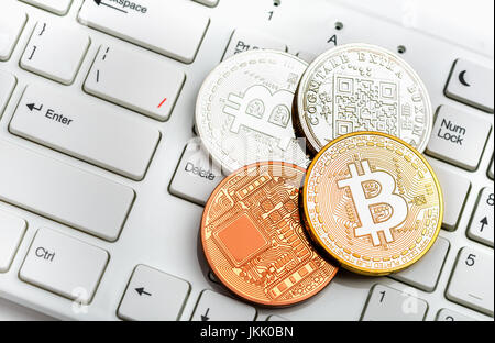 Bitcoin coins gold and silver on white keyboard background Stock Photo