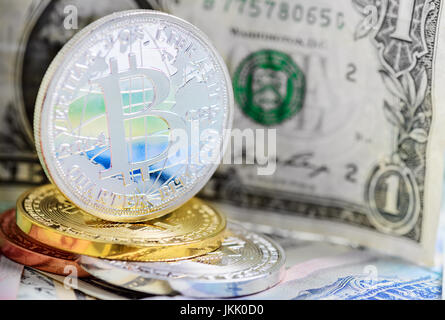 Bitcoin coin over dollar and foreign money background Stock Photo