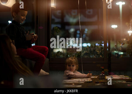 Man using mobile phone, blurred image of inside the restaurant as background. Stock Photo