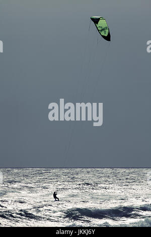 Kiteboarder far out on the ocean. Stock Photo