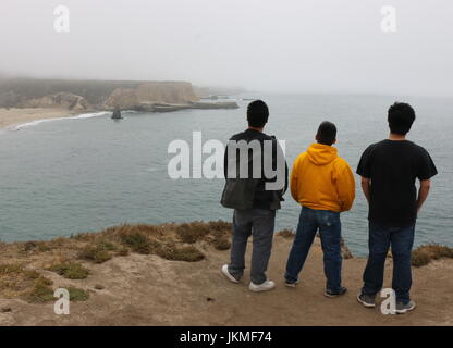 Three young Asian men on a hike overlooking the California coast, Davenport CA. Stock Photo