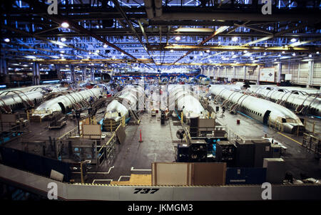 Skilled aerospace workers build a commercial Boeing 737 aircraft. Stock Photo