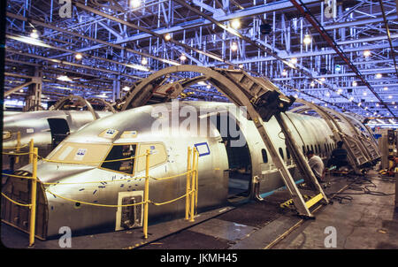 Skilled aerospace workers build a commercial Boeing 737 aircraft. Stock Photo