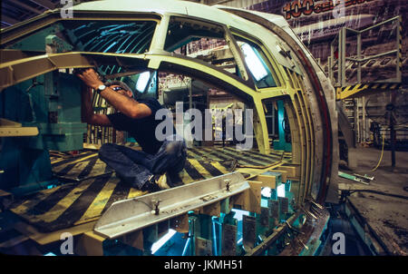 Skilled aerospace workers build a commercial Boeing 737 aircraft. Stock Photo