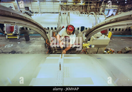 Skilled aerospace workers build a commercial Boeing 737 aircraft. Stock Photo