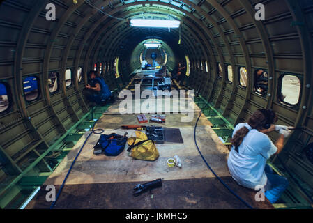 Skilled aerospace workers build a commercial Boeing 737 aircraft. Stock Photo