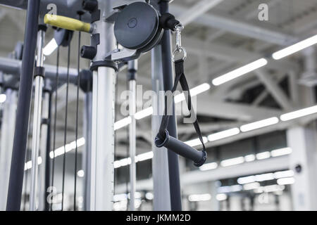 Closeup picture of hanging handle machine in a gym for pulling training Stock Photo