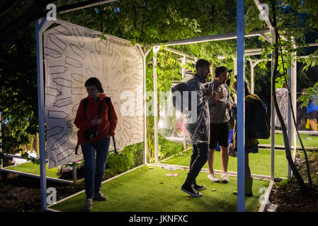 BONTIDA, ROMANIA - JULY 15, 2017: People relaxing in a special chilling natural area decorated with small led lamps at Electric Castle festival Stock Photo