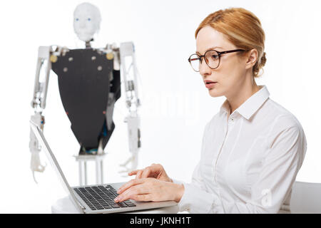 Dynamic capable woman analyzing empiric data Stock Photo
