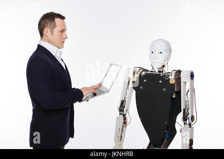 Analytical savvy scientist developing software for robots Stock Photo
