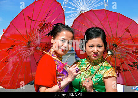 Blackpool, UK. 23rd July, 2017. Blackpool's First international carnival: Todays first international carnival takes place in the seaside town under glorious summer sunshine on the Promenade between Central and South piers. Two women in traditional dress from the Liverpool Chinese community. Kev Walsh Alamy live news Stock Photo