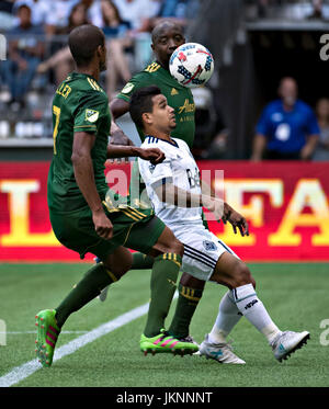 Vancouver, Canada. 23rd July, 2017. Cristian Techera (C) of Vancouver Whitecaps vies with Roy Miller (L) of Portland Timbers during the 2017 Major League Soccer (MLS) match between Portland Timbers and Vancouver Whitecaps at BC Place Stadium in Vancouver, Canada, on July 23, 2017. Portland Timbers won 2-1. Credit: Andrew Soong/Xinhua/Alamy Live News Stock Photo