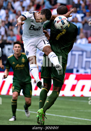 Vancouver, Canada. 23rd July, 2017. Cristian Techera (C) of Vancouver Whitecaps heads the ball with Roy Miller (R) of Portland Timbers during the 2017 Major League Soccer (MLS) match between Portland Timbers and Vancouver Whitecaps at BC Place Stadium in Vancouver, Canada, on July 23, 2017. Portland Timbers won 2-1. Credit: Andrew Soong/Xinhua/Alamy Live News Stock Photo