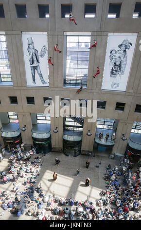 Vancouver, Canada. 23rd July, 2017. Crowds watch dancers perform on the exterior wall of Vancouver Public Library in Vancouver, Canada, July 23, 2017. Vancouver based Aeriosa Dance Company performed dance in the air on the exterior wall of Vancouver Public Library on Sunday. Dancers were hung in the air up from fifth-storey high and performed with a theme about the story of Canada's Indigenous people. Credit: Liang sen/Xinhua/Alamy Live News Stock Photo