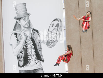 Vancouver, Canada. 23rd July, 2017. Dancers perform on the exterior wall of Vancouver Public Library in Vancouver, Canada, July 23, 2017. Vancouver based Aeriosa Dance Company performed dance in the air on the exterior wall of Vancouver Public Library on Sunday. Dancers were hung in the air up from fifth-storey high and performed with a theme about the story of Canada's Indigenous people. Credit: Liang sen/Xinhua/Alamy Live News Stock Photo