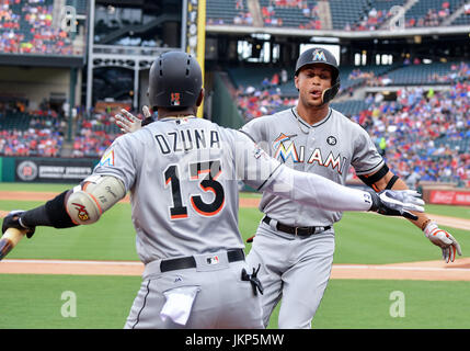 Arlington, Texas, USA. July 24th,  2017:.Miami Marlins right fielder Giancarlo Stanton (27) celebrates with Miami Marlins left fielder Marcell Ozuna (13) after hitting for a home run during a game between the Miami Marlins and the Texas Rangers at Globe Life Park in Arlington, Texas.Manny Flores/CSM Credit: Cal Sport Media/Alamy Live News Stock Photo