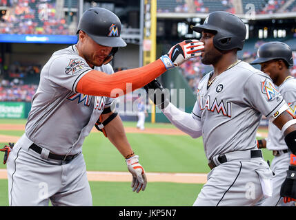 Arlington, Texas, USA. July 24th,  2017:.Miami Marlins right fielder Giancarlo Stanton (27) celebrates with Miami Marlins left fielder Marcell Ozuna (13) after hitting for a home run during a game between the Miami Marlins and the Texas Rangers at Globe Life Park in Arlington, Texas.Manny Flores/CSM Credit: Cal Sport Media/Alamy Live News Stock Photo
