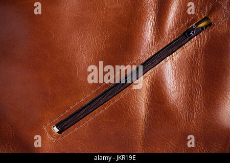 surface and zipper on the leather plate. Stock Photo