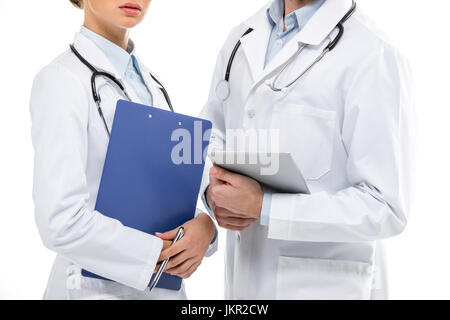 Cropped shot of young professional doctors standing with clipboard and digital tablet Stock Photo