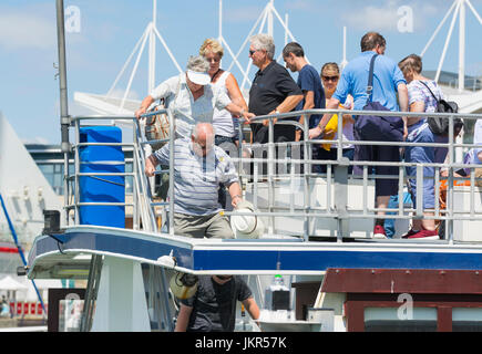 Ferry passengers disembarking from a boat. Stock Photo