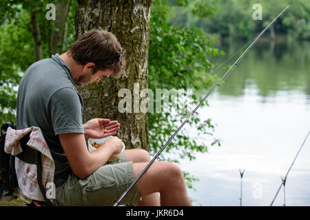 Fisherman preparing lure, fishing getaway vacation hobby concept Stock Photo