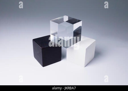 Various block shapes arranged in stack on gray background Stock Photo