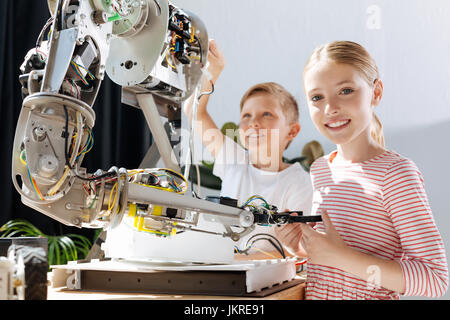 Happy kids taking part in the construction of robot Stock Photo