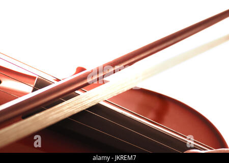 Violin and bow detail against a white background. Empty copy space for Editor's text. Stock Photo