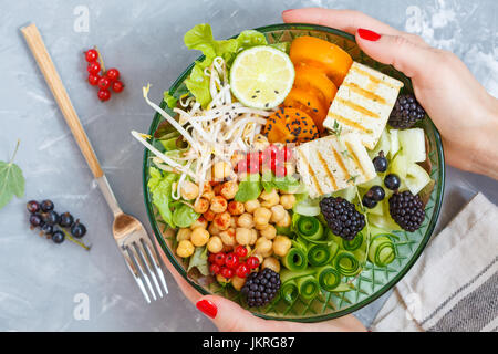 Healthy vegan lunch - buddha bowl of vegetables, chickpeas and tofu. Stock Photo