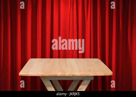 wooden table with red curtain background Stock Photo