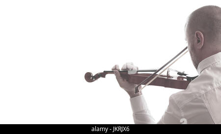 Violinist playing in a concerto, against a white background. Empty copy space for Editor's text. Stock Photo