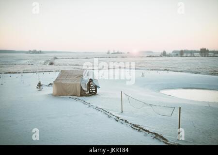 Beautiful winter morning. Landscape view. Sun rise comes up above the horizon, cold winters light. Stock Photo
