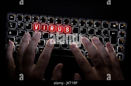 Virus keyboard is operated by Hacker. Stock Photo