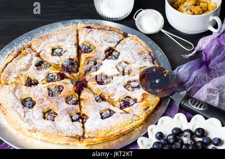 Blueberry Fruit sweet pie and a roller cutter knife Stock Photo