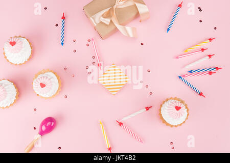 top view of cakes with candles and gift boxes with confetti mock-up, birthday party Stock Photo