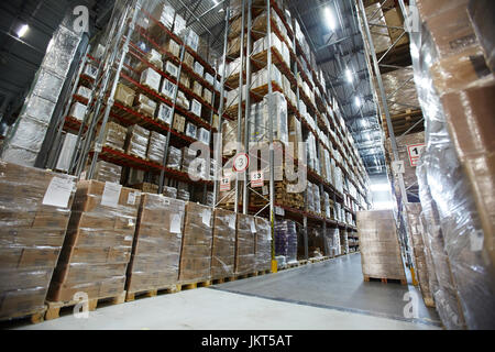 Wide angle view of packed boxes on tall racks in large scale distribution warehouse Stock Photo