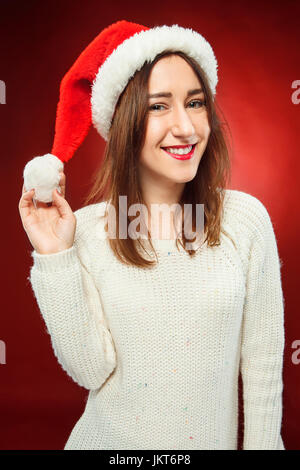 Surprised christmas girl wearing a santa hat Stock Photo