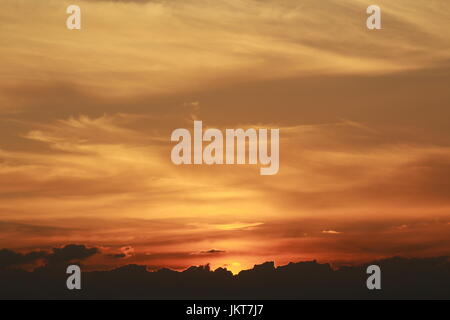 Golden sunset over the clouds Stock Photo