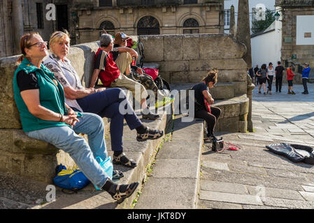 musician with guitar and pilgrims in Santiago de Compostela, Spaine, Europe. Camino de Santiago. Stock Photo