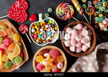 Colorful candies, jelly and marmalade on stone background. Top view Stock Photo