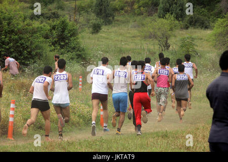 Anantnag, India. 24th July, 2017. Kashmiri men run to qualify the test during a Police recruitment rally on July 24, 2017 in Anantnag, India. A recruitment drive by the police in Kashmir evoked an overwhelming response, with nearly 3,000 young men and women turning up for it. The candidates, who have qualified the physical test, will have to appear in the written test for final selection for which the dates will be issued separately. Credit: Muneeb Ul Islam/Pacific Press/Alamy Live News Stock Photo