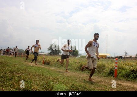 Anantnag, India. 24th July, 2017. Kashmiri men run to qualify the test during a Police recruitment rally on July 24, 2017 in Anantnag, India. A recruitment drive by the police in Kashmir evoked an overwhelming response, with nearly 3,000 young men and women turning up for it. The candidates, who have qualified the physical test, will have to appear in the written test for final selection for which the dates will be issued separately. Credit: Muneeb Ul Islam/Pacific Press/Alamy Live News Stock Photo