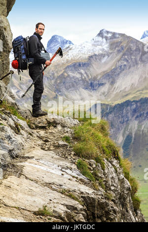 Man walks on dangerous trail in alpine mountains. Alps, Allgau. Stock Photo