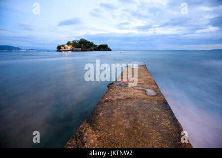 Perspective view of a stone pier in a completely calm sea in Anilao, Batangas, Philippines Stock Photo