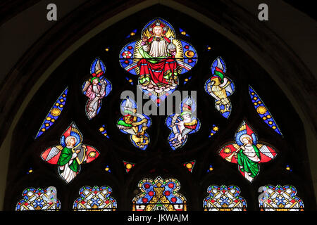 Jesus resurrected, symbols of four Evangelists, angel musicians, tracery, stained glass window, by William Wailes, 1853, Swaffham, Norfolk, EnglandUK Stock Photo